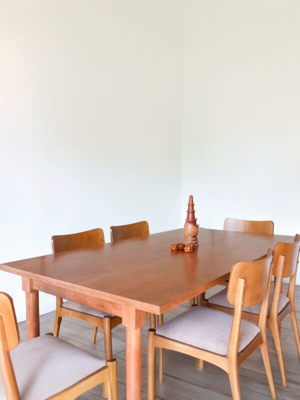 Mesa de comedor Madrid en madera maciza de lenga, diseño nórdico con patas cilíndricas y acabado natural, acompañada de sillas tapizadas en tono neutro.